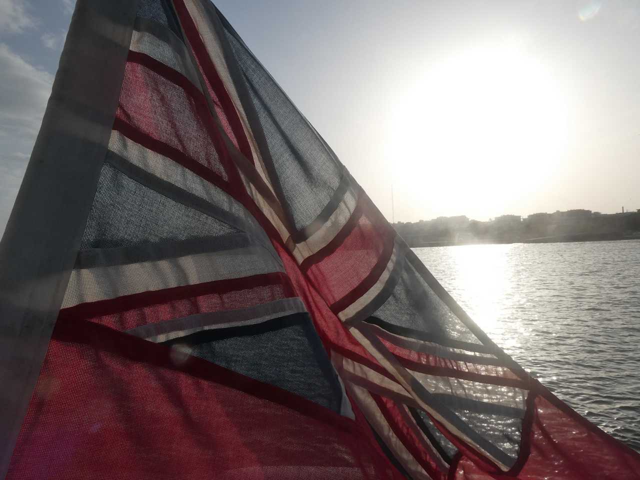 The sun sets through our fluttering flag.