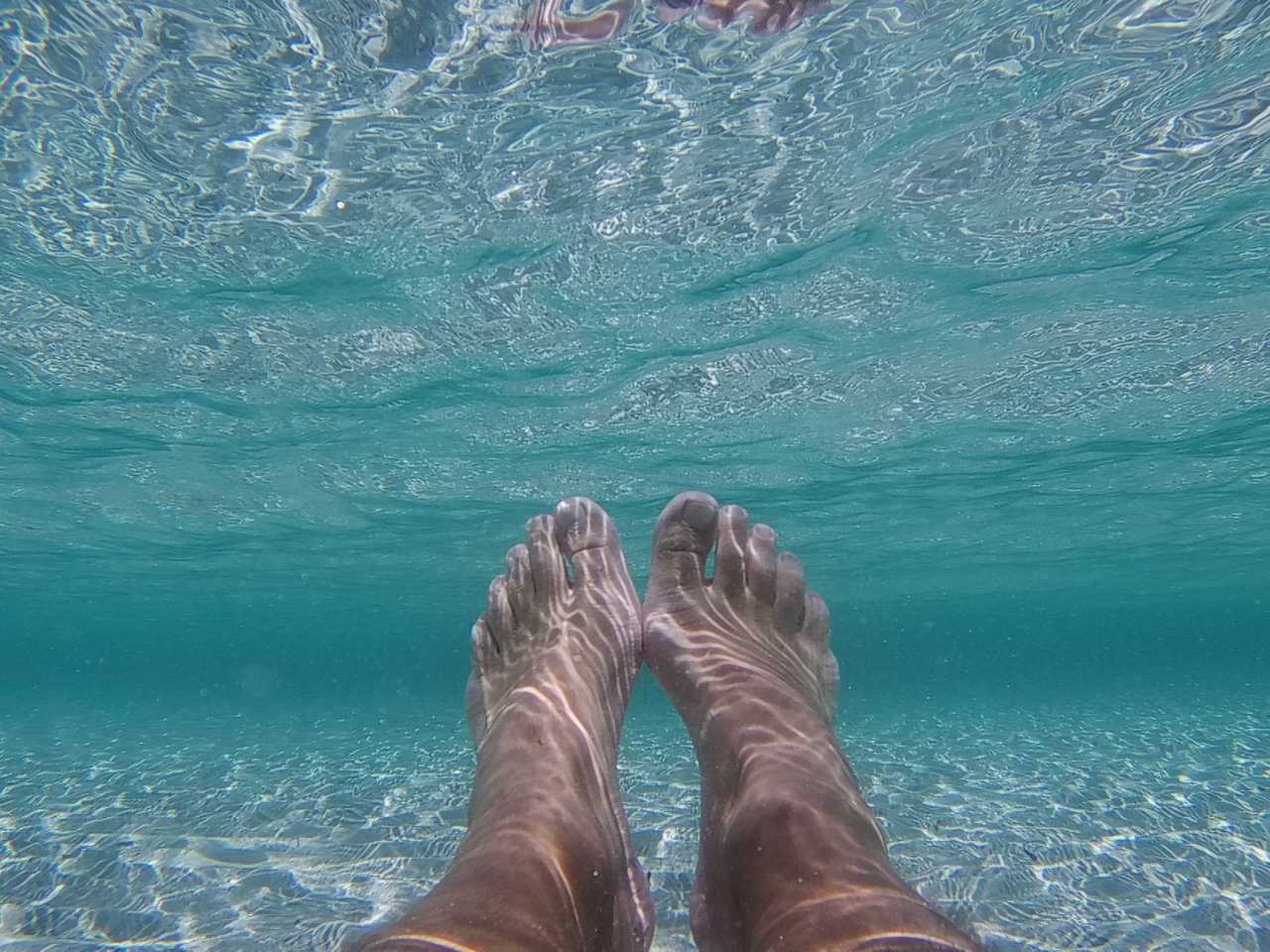 Clear blue water polluted by Iain’s toes.